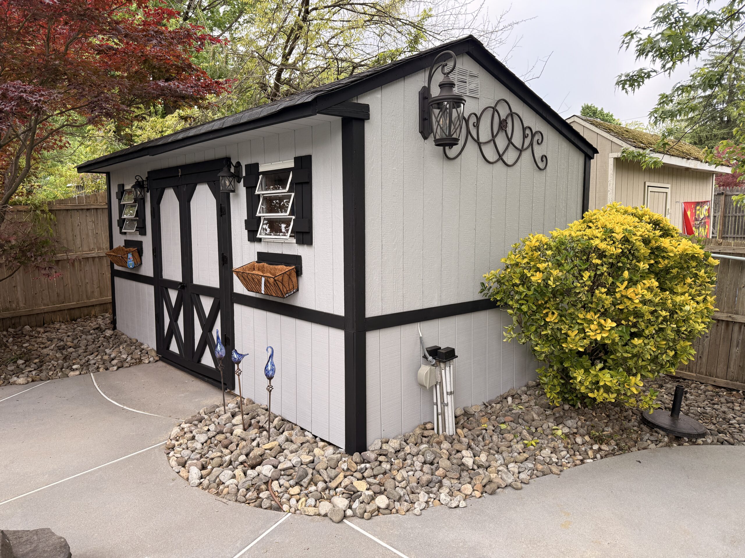 Finished shed with painted siding and black trim